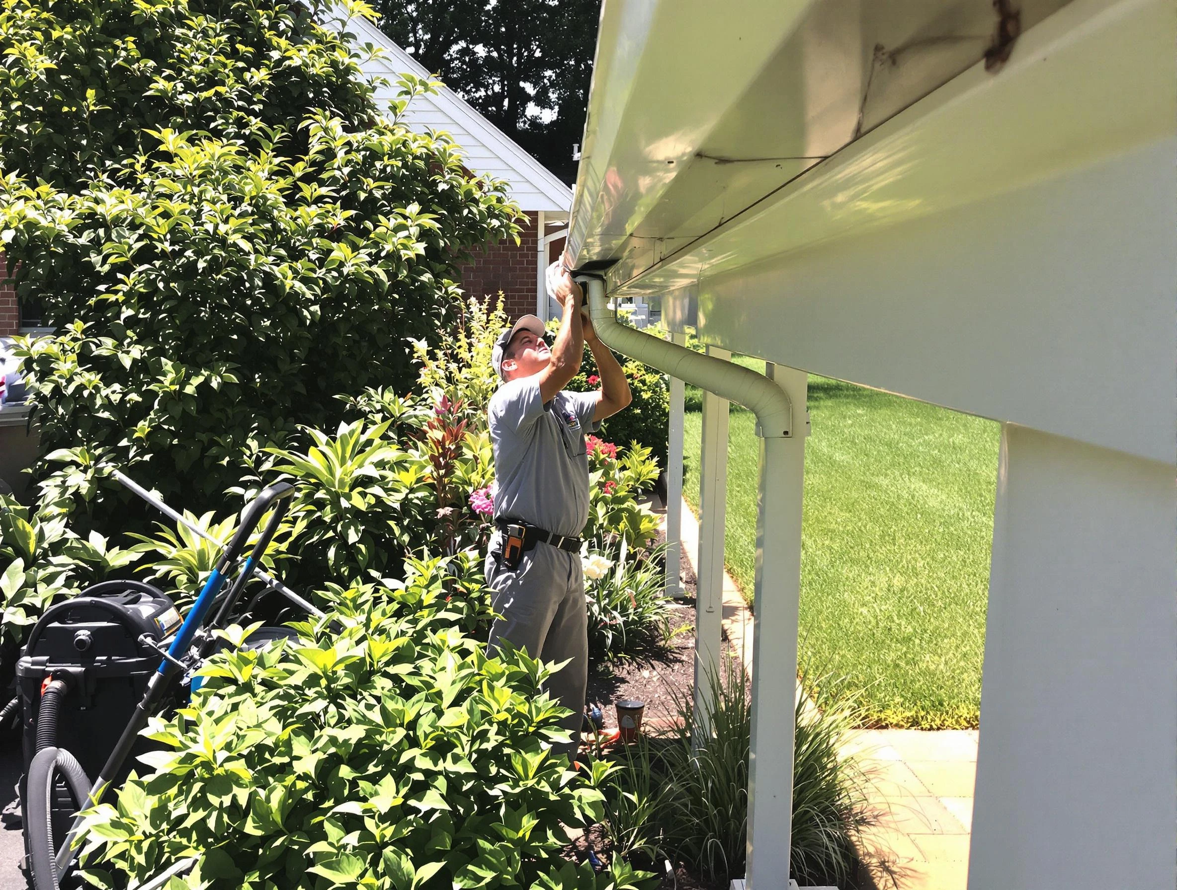 Technician flushing a blockage from a downspout in Painesville, OH